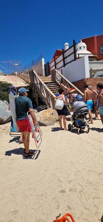 Bañistas en un acceso con muchos defectos